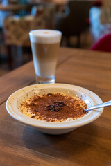Delicious dessert with latte served in cozy café setting