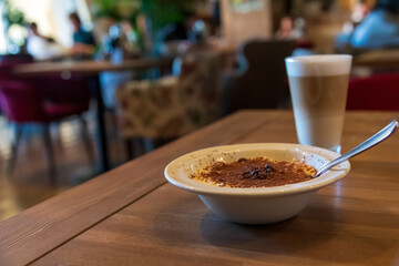 Enjoying dessert and coffee in a cozy cafe setting during afternoon hours