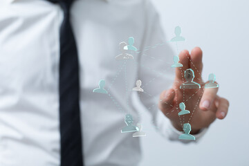 Close up of a businessman touching a virtual social network interface representing connection, teamwork, and global business concepts.