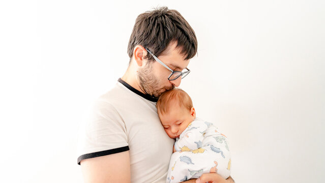 Father embracing newborn baby with love and care