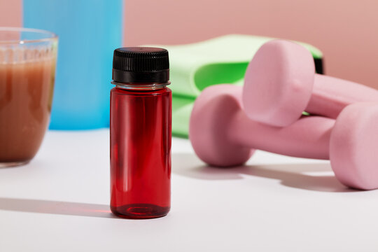Closeup of energy shot amid pink fitness equipment