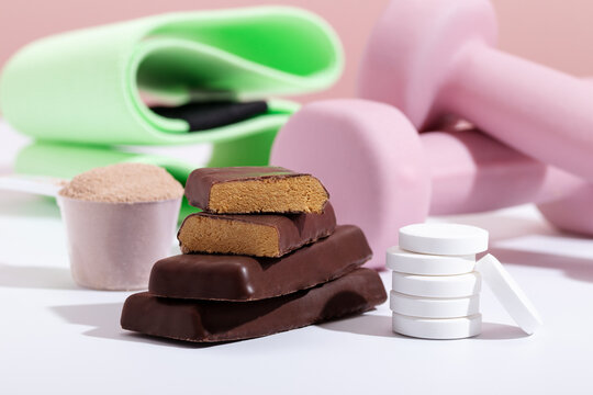 Workout nutrition essentials against pink equipment