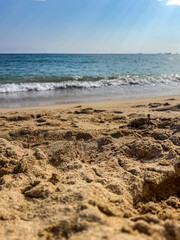 Sandy Beach with Soft Ocean Waves and Blue Sky