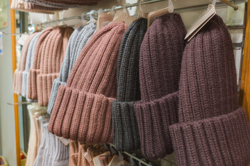 Knit winter hats displayed on store shelves