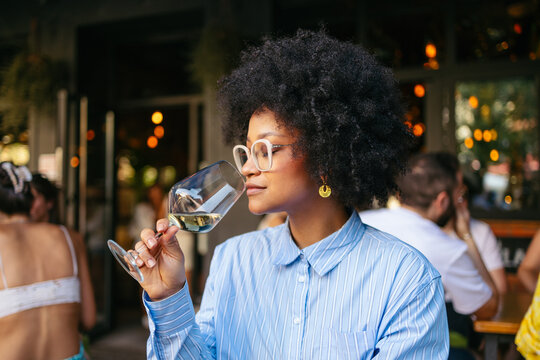 Woman enjoying a glass of wine in downtown setting