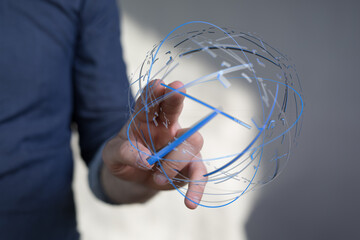 Close up of a hand holding a digital sphere, representing the global network, data, and connection....