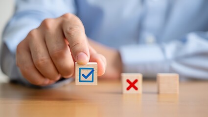 Hand holding wooden cube with checkmark symbol near other cubes decision making choice