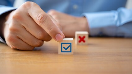 Hand selects wooden cube with blue checkmark over red cross check mark decision