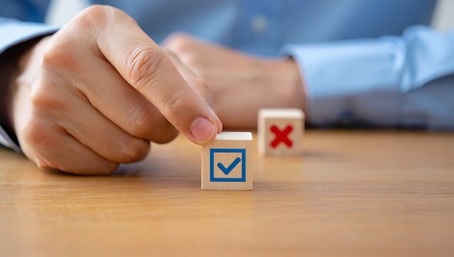 Hand selects wooden cube with blue checkmark over red cross check mark decision