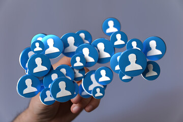 Hand holding a network of social icons representing human connection, online community, social...