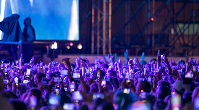 People taking a Video With Smartphones at Concert - Powered by Adobe