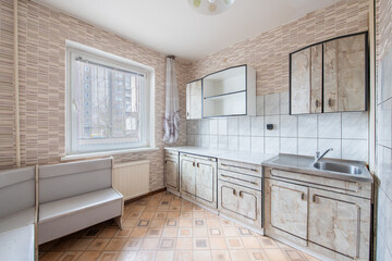 Kitchen Interior. Home, House interior. Sink and Faucet, Cabinets. Window in Background. Old Soviet Russian Poor Interior.