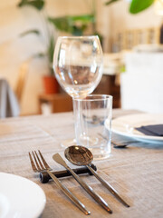 Table set with modern cutlery and glassware