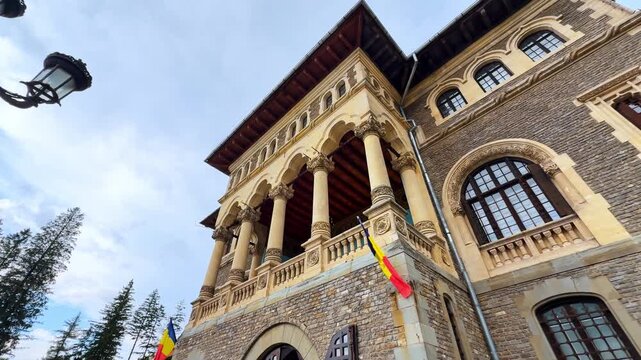 Stunning architecture of Cantacuzino Castle in Busteni, Romania. Famous landmark from low angle view on rainy day.