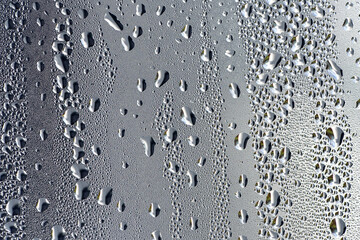 background, drops of morning dew, condensation on the glass. wet glass. water drops close-up. beautiful background for text. Spray cool condensate water on the glas. unusual, abstract. macro photo