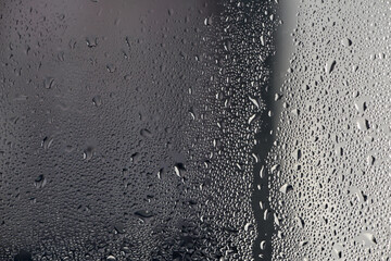 background, drops of morning dew, condensation on the glass. wet glass. water drops close-up. beautiful background for text. Spray cool condensate water on the glas. unusual, abstract. macro photo