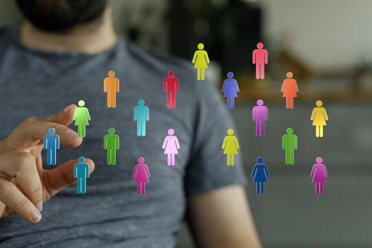 Abstract image of connection, communication and social network in business and community. Person is reaching for colorful group of diverse indiv - Powered by Adobe