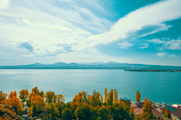 A beautiful view of a lake with a cloudy sky in the background