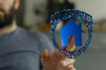 Conceptual image with a hand holding a house icon inside a shield, symbolizing protection and...