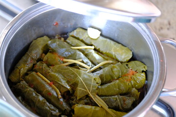 Close-up of homemade stuffed vine leaves in a pot. Stuffed vine leaves with meat cooked in a pot. Traditional Turkish cuisine. Home cooking. Healthy eating.