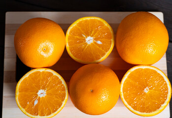Fresh oranges on cutting board