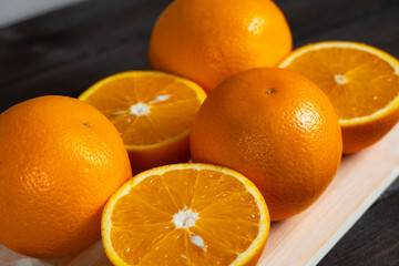 Fresh oranges on cutting board