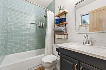 A bathroom that features a toilet, a sink, a bathtub, and a mirror