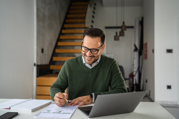 Obraz premium Mature man working from home office smiling during video call