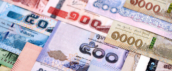 Thai Baht currency money bills. THB currency banknotes in pile with different denomination close up