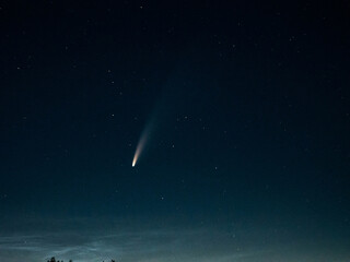 spectacular comet dash across night sky with glowing nucleus and scattered celestial bodies