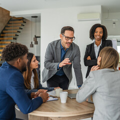 Diverse business professionals having informal meeting in modern office