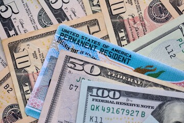 American US dollars money bills with permanent resident green card diversity visa close up