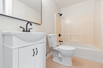 A wellequipped bathroom featuring a toilet, sink, and a bathtub