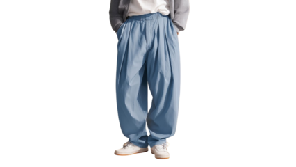 PNG of A stylish male model in casual blue wide-leg trousers and white sneakers, showcasing contemporary street fashion.