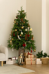 Cozy Christmas tree with gifts and wooden horse. Ample copy space for text. Ideal holiday background for social media, email, and e-commerce. Christmas background