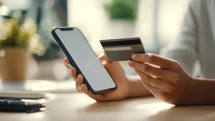 Close up of hands using a smartphone and credit card for an online purchase, emphasizing convenience and security. The image highlights digital finance trends and contactless payment technology - Powered by Adobe