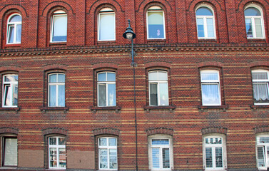 Building with many windows. Urban scene. City life. old red brick building