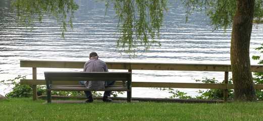 Time to Reflect - Man on park bench at water's edge
