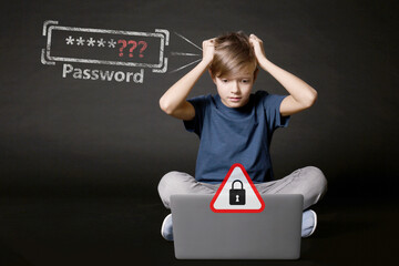 Shocked boy with laptop forgot password. Dark background