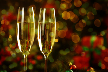 Sparkling wine in glasses against blurred lights, bokeh effect. New Year greeting card