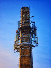 Telecommunication antenna tower on industrial chimney