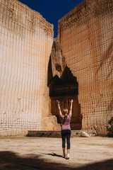 Woman standing in the monumental stone walls of Lithica, Pedreres de s'Hostal, in Menorca, Spain.