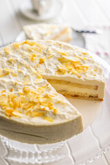 Sweet creamy cake on white table.