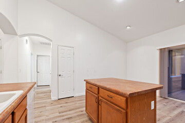 A kitchen with wooden cabinets, stainless steel appliances, and tile