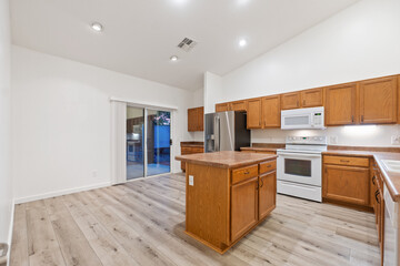 A spacious kitchen with beautiful wooden cabinets and a large island