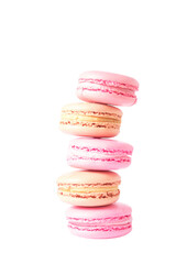 Vertical stack of five pastel macarons (pink and beige) on transparent background. Soft texture,...