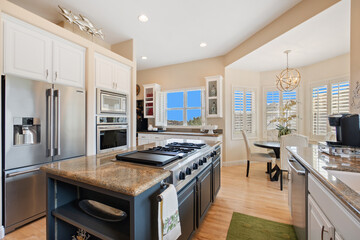 A modern kitchen with a spacious island and sleek stainless steel appliances