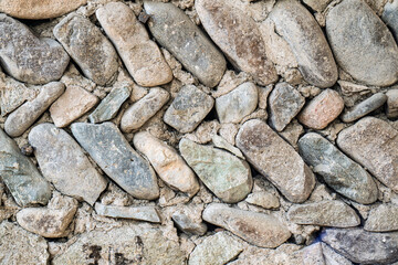 A wall made of rocks with a pattern of zigzags