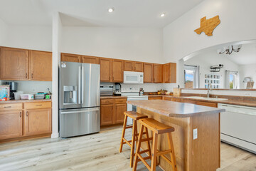 A kitchen with wood cabinets, a white stove, and granite tops