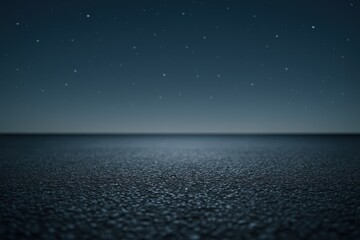 Dark asphalt foreground with moody night sky and subtle stars for product showcase